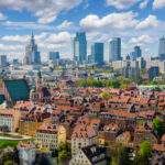 Aerial view of Warsaw’s Old Town and modern skyline, capturing the city environment experienced by Americans living in Poland.