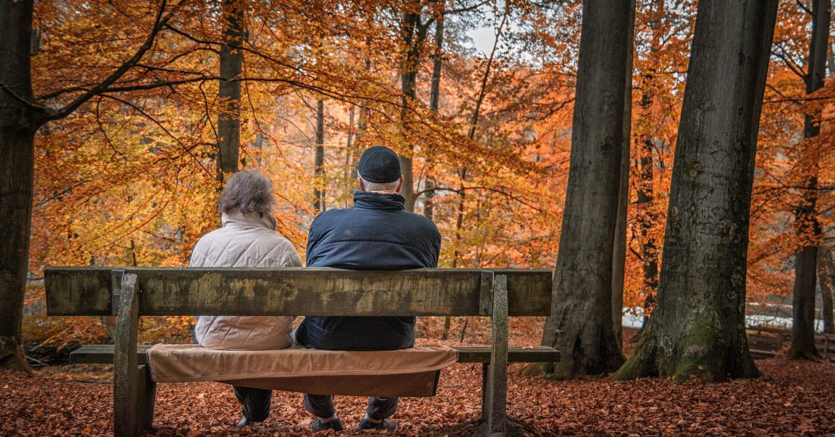 Retiring in Japan as a foreigner is actually quite a common occurence for Americans. Pictured: two older expats sitting in on a bench in the fall.