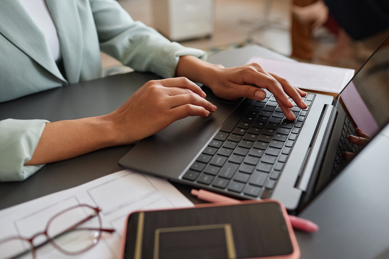 Businesswoman working on her laptop, researching delinquent FBAR filing procedures for foreign account compliance.