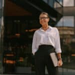 Confident businesswoman working internationally, potentially qualifying to exclude income using Form 2555.