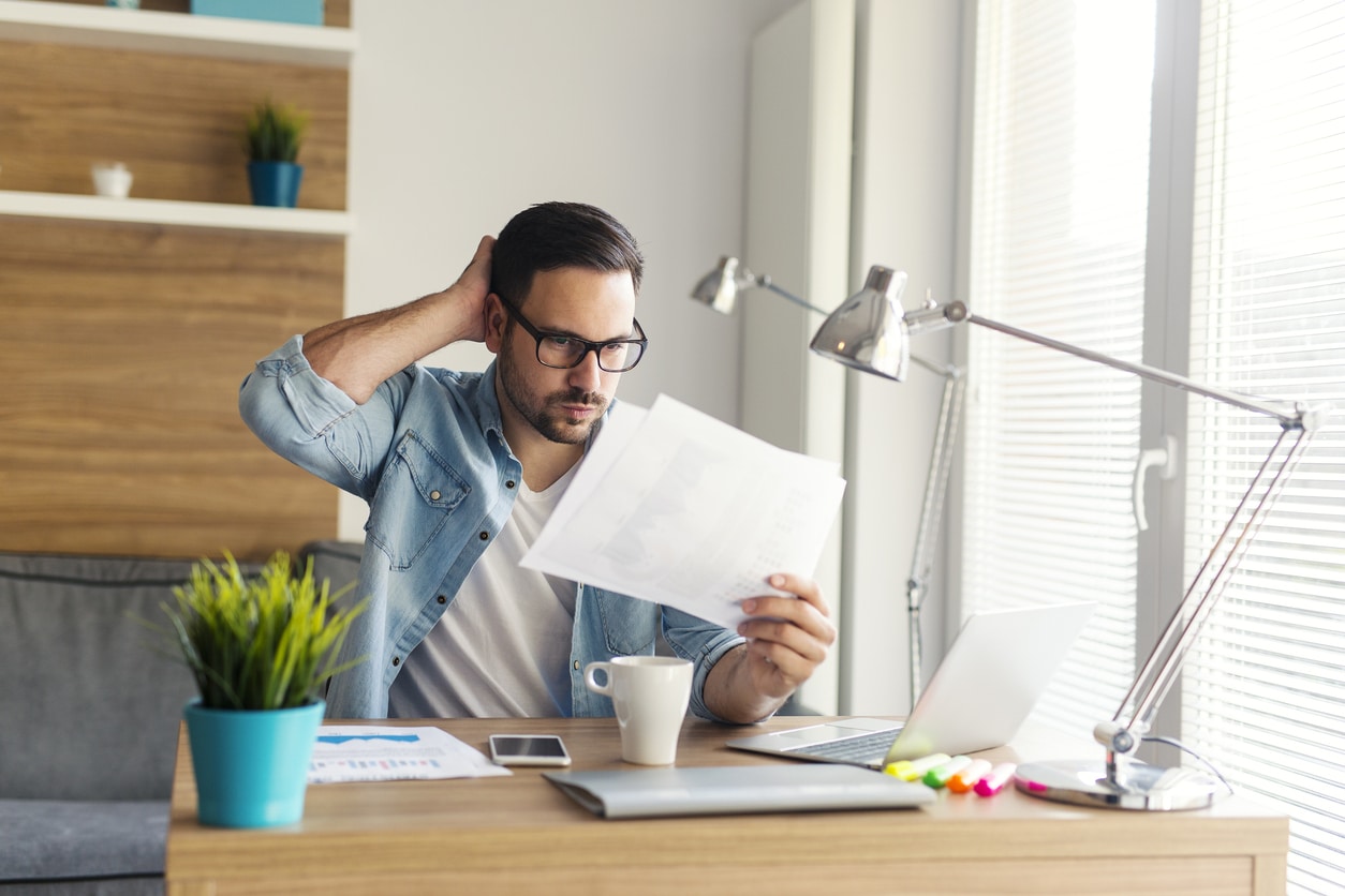 Confused freelancer reviewing charts and numbers, facing the complexities of the foreign tax credit limitation.