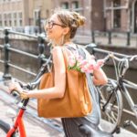 American living in the Netherlands walks with her bike