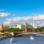 Summer view of the Moscow Kremlin, river and sightseeing boats, a familiar cityscape for Americans living in Russia.