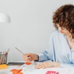 US expat works on her taxes at a table.