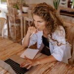 Woman working on her laptop, preparing to claim the foreign earned income exclusion.