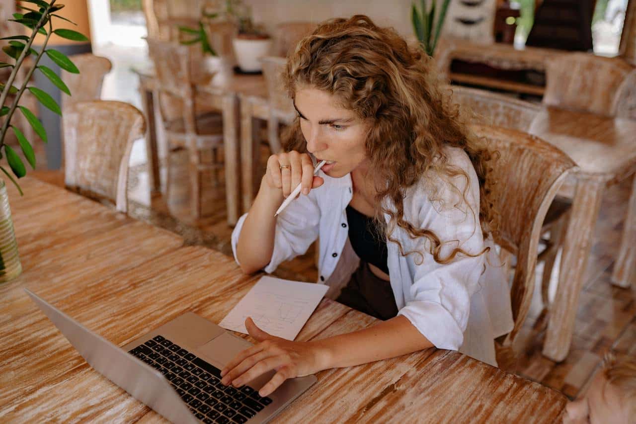 Woman working on her laptop, preparing to claim the foreign earned income exclusion.