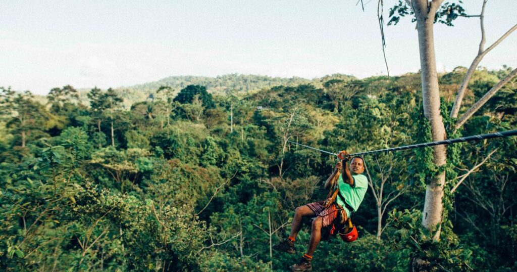 Man ziplining  over the trees in Costa Rica