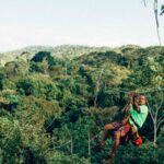 Man ziplining over the trees in Costa Rica