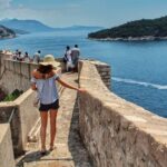Digital nomad in Croatia walking along the Dubrovnik waterfront.