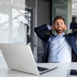 Satisfied professional after filing taxes—likely relieved to understand foreign tax credit vs foreign earned income exclusion rules.