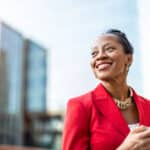 Businesswoman on the move in a city setting, staying compliant with foreign operations through Form 8858.