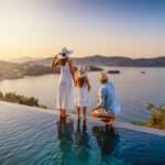 Family by a pool at sunset during an overseas stay, reflecting the lifestyle abroad that still comes with US expat taxes.