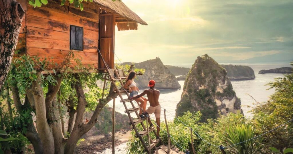 Treehouse on a tropical island with a heterosexual couple relaxing outside