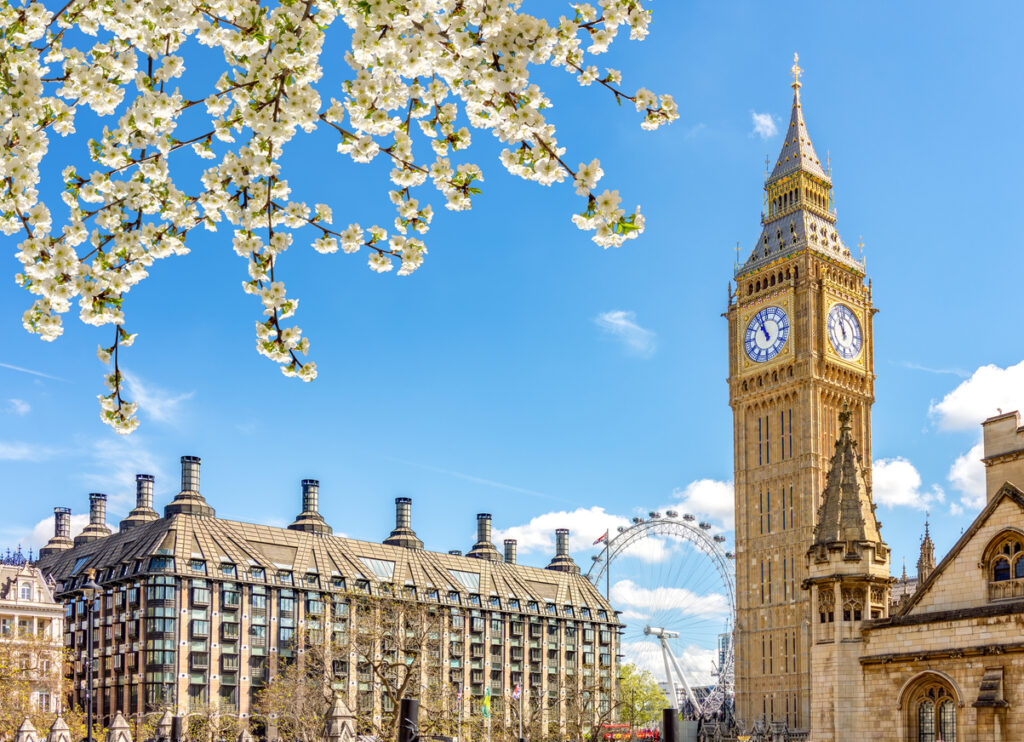 Iconic view of Big Ben in spring, capturing the charm that draws many to consider moving to the UK from the USA.