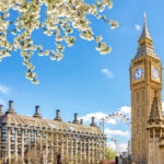 Iconic view of Big Ben in spring, capturing the charm that draws many to consider moving to the UK from the USA.