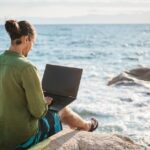 Digital nomad working overlooking the sea