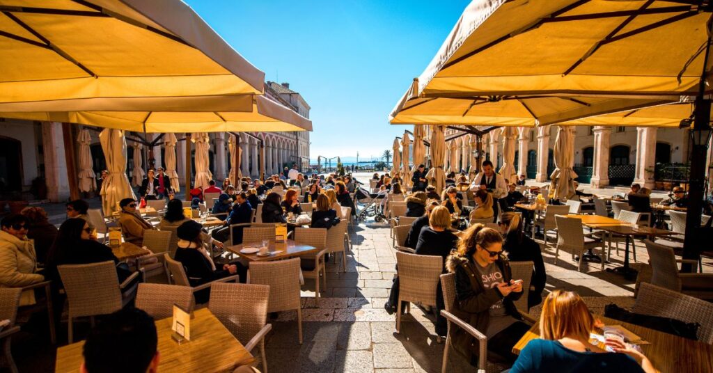 A sunny terrace full of people living in Croatia