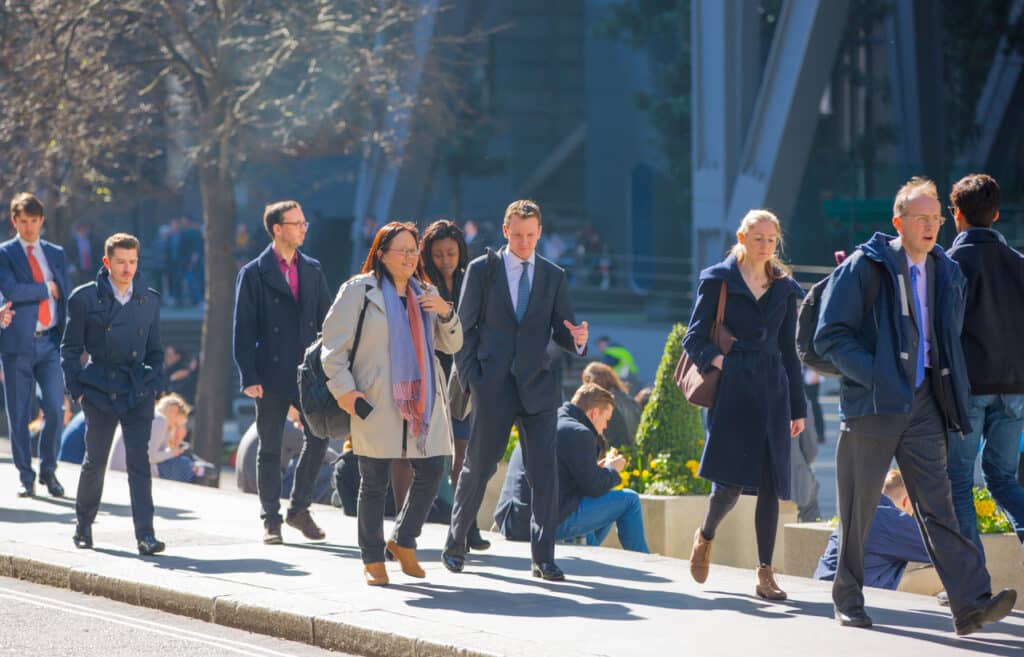 Business professionals walking through the City of London, representing the career opportunities tied to the UK Skilled Worker visa.