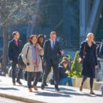 Business professionals walking through the City of London, representing the career opportunities tied to the UK Skilled Worker visa.