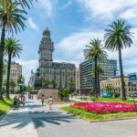 Visitors crossing Plaza Independencia in Montevideo, a landmark in the capital for those considering where to retire in Uruguay.