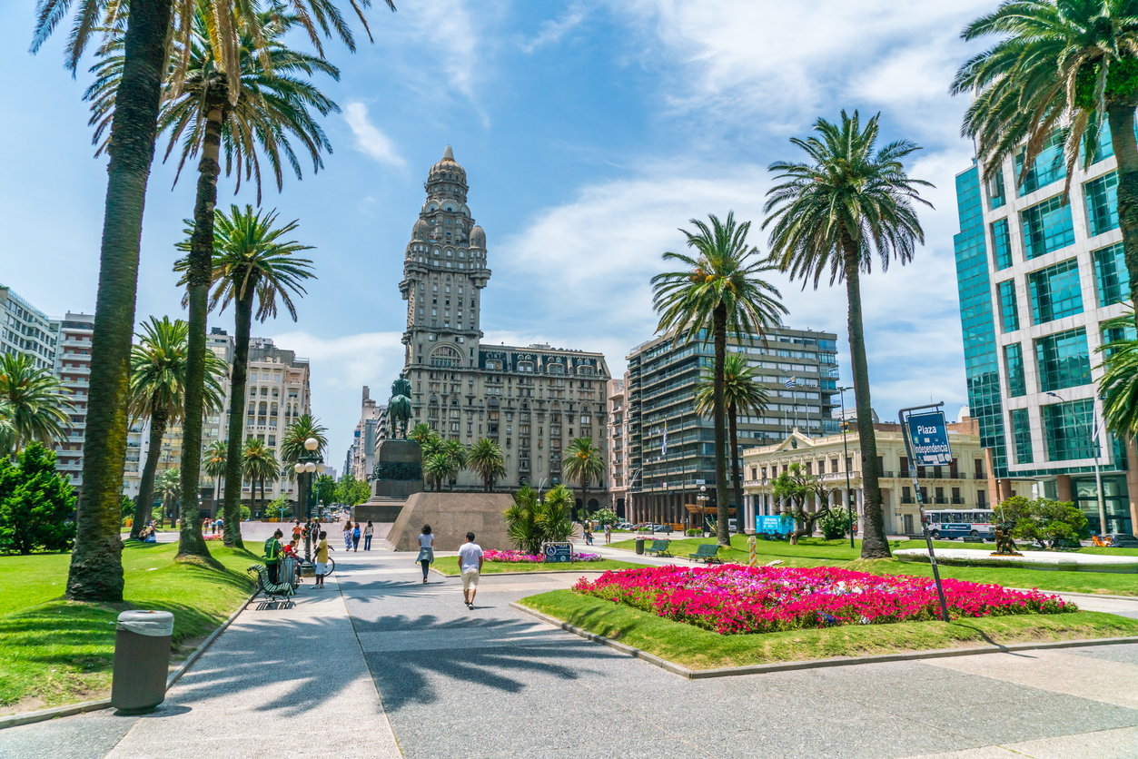Visitors crossing Plaza Independencia in Montevideo, a landmark in the capital for those considering where to retire in Uruguay.