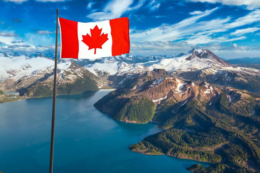 Aerial view of Garibaldi Lake with Canadian flag overlay—an iconic landscape for anyone earning taxable income in Canada.