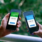 Two people using smartphones to send and receive a payment, illustrating the ease of transferring money internationally.