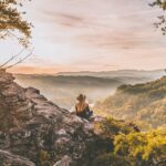 US expat contemplates the horizon during a hike in Eastern Europe.