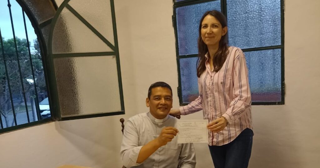 Bright!Lights Philanthropy Project _ Dafne Adams, Client Engagement Specialist, delivering the donation to Father Luis, from Parroquia M. Inmaculada