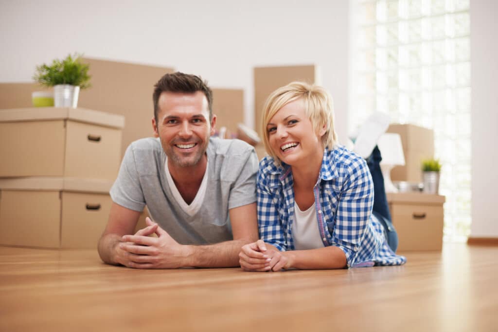 Happy homeowners celebrating a new house, reflecting the lifestyle appeal often associated with a golden visa.