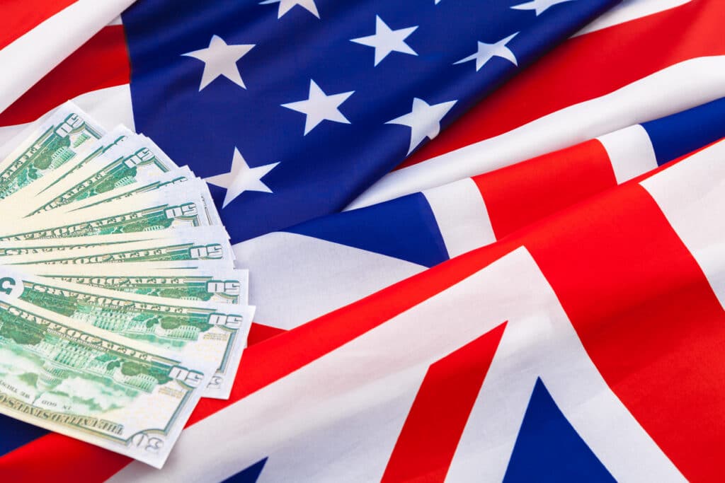 American flag and cash money, representing the financial ties covered by the US UK tax treaty.