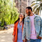 Smiling couple visiting Barcelona, where expats may benefit from tax perks under the Beckham Law in Spain.