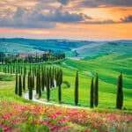 Tuscany’s rolling hills and cypress-lined paths, capturing the peaceful countryside lifestyle many imagine when they retire in Italy.