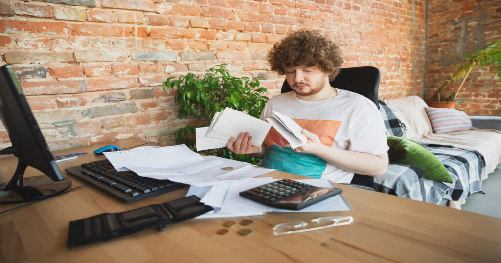 a man looking confused by paperwork