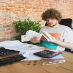 a man looking confused by paperwork