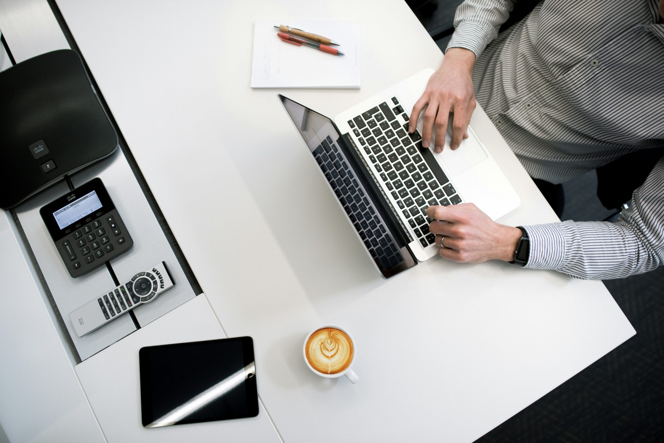 man sitting in a table while using his laptop