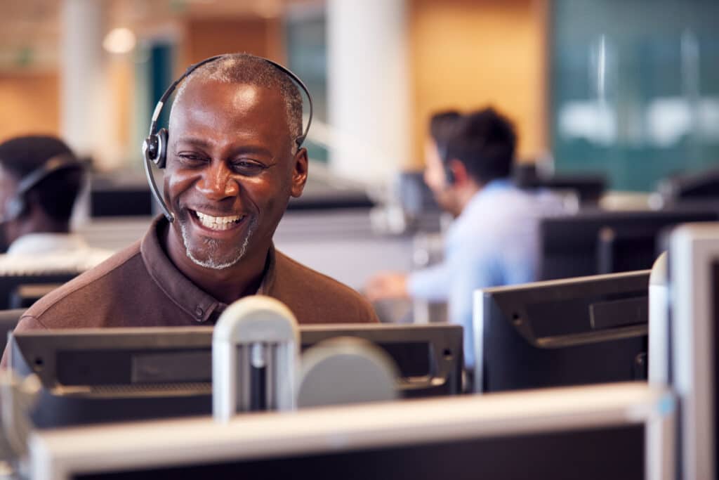 Mature businessman wearing a headset, representing a self-employed professional whose income may be reported on Schedule C.