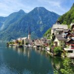 Charming lakeside village surrounded by mountains, representing the storybook lifestyle of Americans living in Austria.