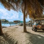 Rickshaws and golf carts near the beach—relaxed transportation for Americans living in Belize’s tropical settings.