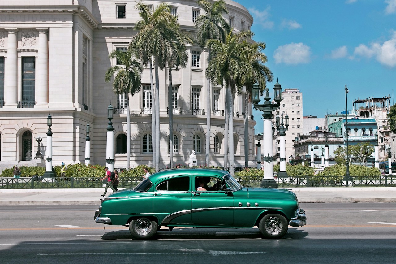 A quiet street scene in a tropical setting, reflective of daily life for Americans living in Cuba.