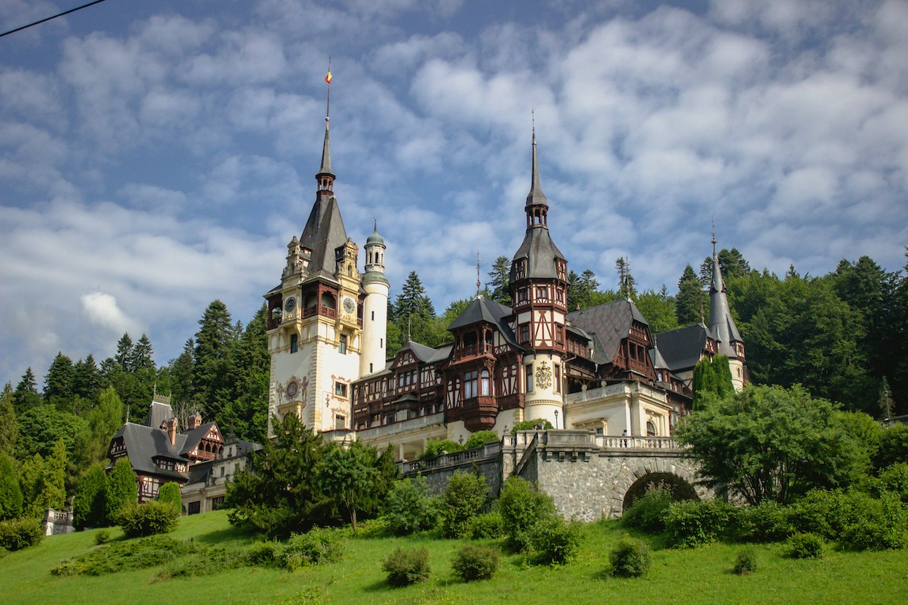 Hilltop castle under cloudy skies, echoing the historic beauty explored by Americans living in Romania.