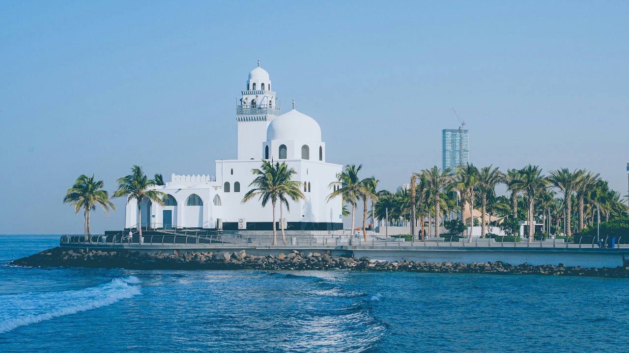 Modern white building by the water, echoing the urban surroundings of many Americans living in Saudi Arabia.