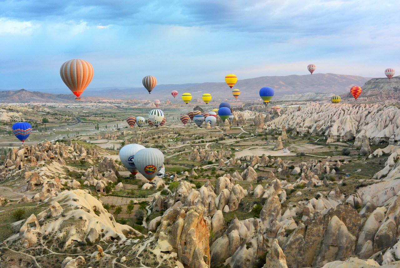 Colorful hot air balloons fill the sky, capturing a sense of adventure often embraced by Americans living in Turkey.