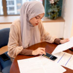 Young woman reviewing expat tax advice to manage her finances abroad.