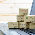 Laptop displaying a range of investment options like ETFs and mutual funds—reminders of what may need to be reported on a PFIC form.