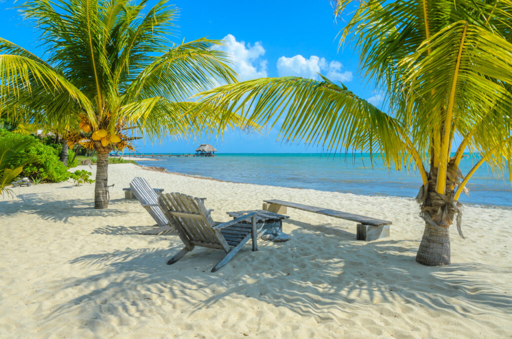 Paradise beach on the tropical coast of Placencia, a popular destination for those looking to retire in Belize.