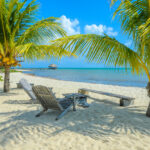 Paradise beach on the tropical coast of Placencia, a popular destination for those looking to retire in Belize.