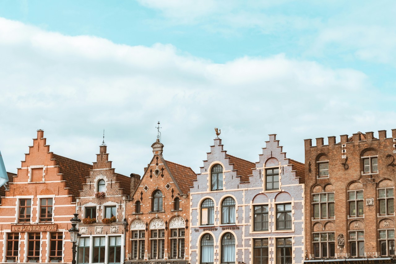 Modern concrete buildings under clear skies, reflecting the urban landscape familiar to Americans living in Belgium.
