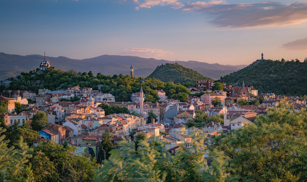 Peaceful town surrounded by forested hills, reflecting the slower pace of life enjoyed by Americans living in Bulgaria.