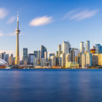 Toronto skyline glowing at dusk, a vibrant snapshot of urban life in Canada.